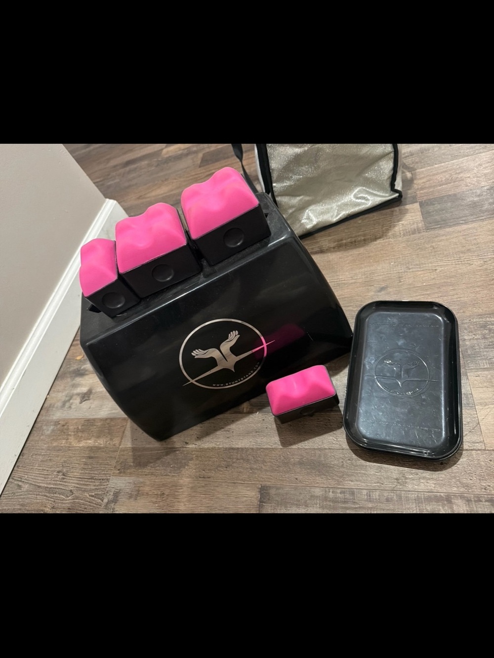Pink and black stunt stand for flyers.